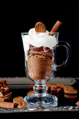 Sweet dessert with chocolate, cocoa, nuts and whipped cream