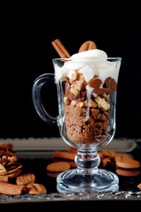 Sweet dessert with chocolate, cocoa, nuts and whipped cream