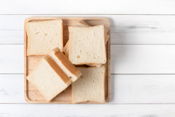 white sliced bread on wood plate, top view and copy space