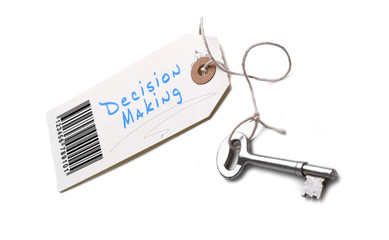 A silver key with a tag attached with a Decision Making concept written on it.