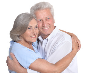 Happy old couple embracing on a white background