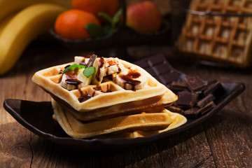 Delicious waffles with banana and chocolate