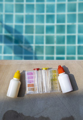 Liquid water testing test kit with space on swimming pool, outdoor day light