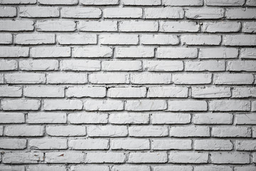 Old brick wall with peeling paint.Rough stone masonry.Vintage Design Element.Worn, broken wall requiring painting