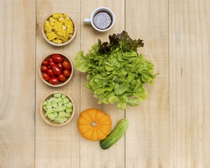 Fresh vegetable in wooden bow over wooden background, healthy concept food