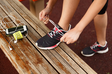Female runner tying her sneakers