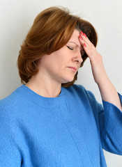 Portrait of woman experiencing a migraine