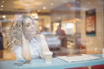 Thoughtful woman sitting at counter