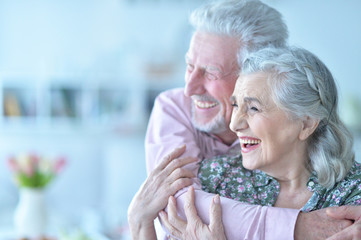 Happy elderly couple embracing