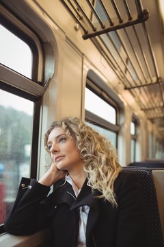Woman looking out through train window