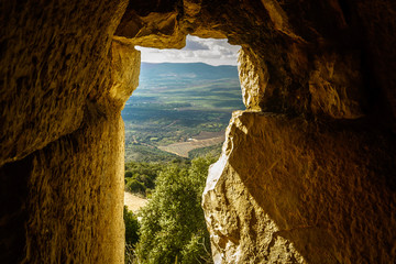 Amazing landscape view of North Galilee mountains and valley thru ancient medieval fortress entrance, Israel. Concept: discovery, travel, vision - obrazy, fototapety, plakaty