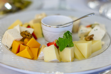 Plate of cheese with honey and fruits