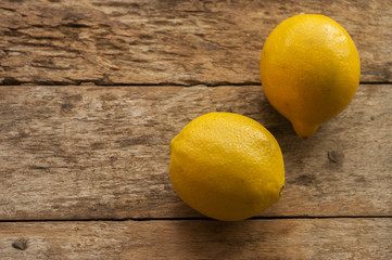 Lemon on old wooden background. Shallow depth of field, toned photo.