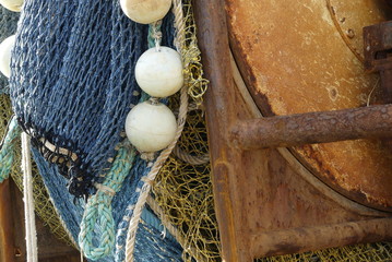Closeup of trawl net wrapped around winch drum on the stern of a fishing boat