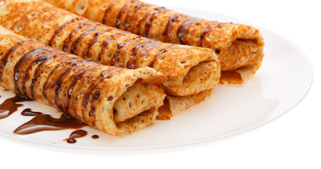Rolled pancakes on a plate.