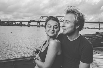 young happy loving couple on the river bank