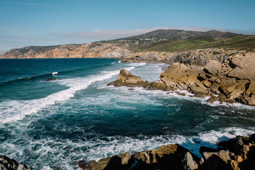 large rocks on the beach and in the ocean