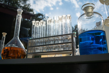 chemical test tubes in the open air (sky in the background)
