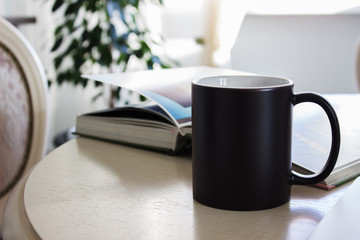 Black mug, cup on a table, Mockup