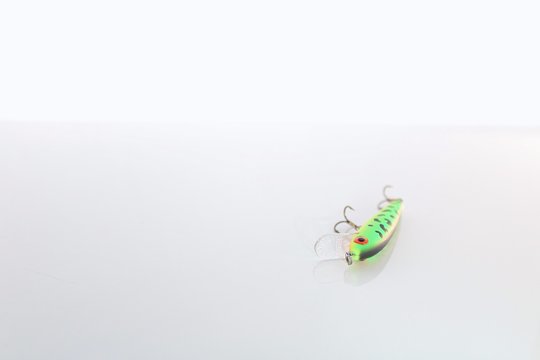 Small Green and Red Fishing Lure Isolated on White Background