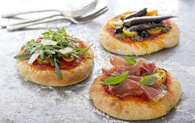 Mini pizzas with sardines prosciutto ham