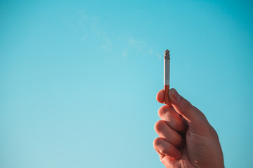 Hand Hold Cigarette with Smoke as the Cloud Idea Inspiration for World Campaign