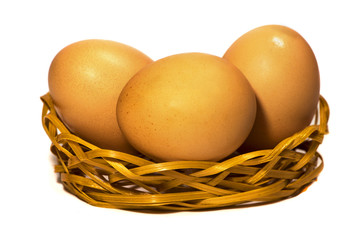 Eggs in hay on a white background