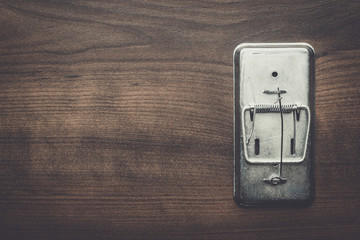 empty mousetrap on the wooden table background