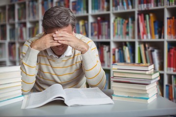 Tensed school teacher studying in library
