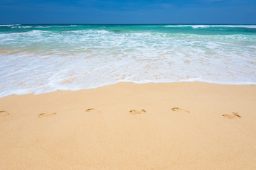 Fototapeta na wymiar Footprints in the sand stretching to the Indian Ocean island of Sri Lanka.