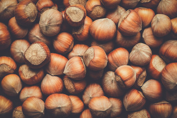 hazelnuts on the brown wooden table background