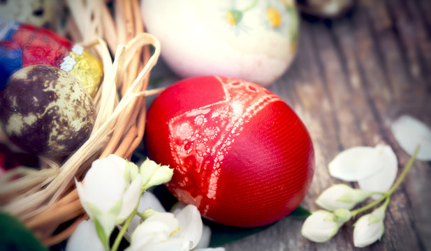 Selective focus on red Easter egg on rustic wooden table