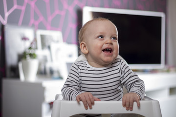 Funny baby boy in the room with modern design