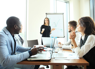 Woman making a business presentation to group
