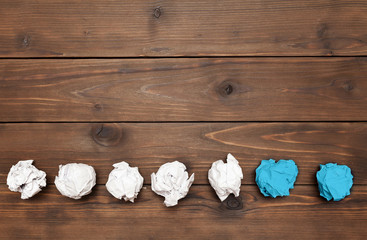 balls of paper on wooden background symbolizing the days of the week