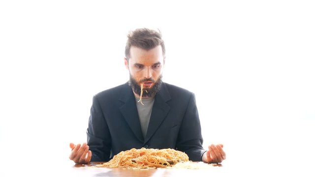 Dirty disgusting businessman looking at you and eating pasta on the table. Crazy nasty consumerism concept, studio isolated on white background.