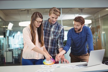 Graphic designers interacting with each other while working
