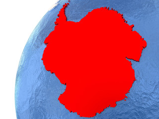 Antarctica on metallic globe with blue oceans