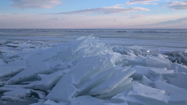 Dolly shot of small icebergs and icicles