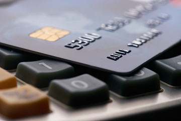 Close up of plastic credit or debit card on calculator