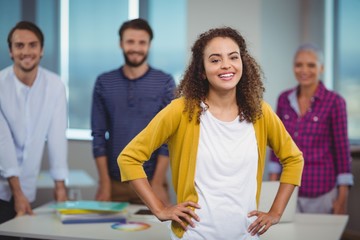Portrait of smiling designer with her colleagues