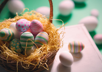 Basket with colorful Easter eggs, close up photo