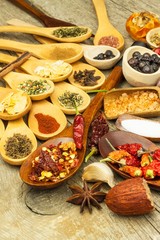 Spices on wooden spoons. Sales of exotic spices. Seasoning food. Aromatic spices.