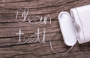 Words clean teeth of dental floss - obrazy, fototapety, plakaty