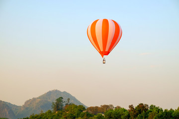 Hot air balloon flying on sky and landscape background