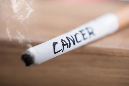 Cancer Text On Burning Cigarette