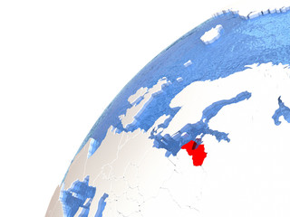 Latvia on metallic globe with blue oceans