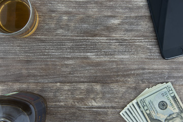 US dollars banknotes, glass of whiskey and bottle
