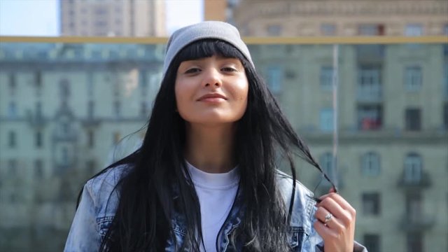 Close up of happy young hispanic latina woman looking to camera. Making funny faces.
