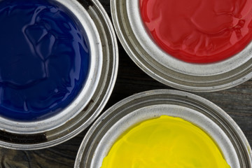 Jars of paint, blue, red and yellow